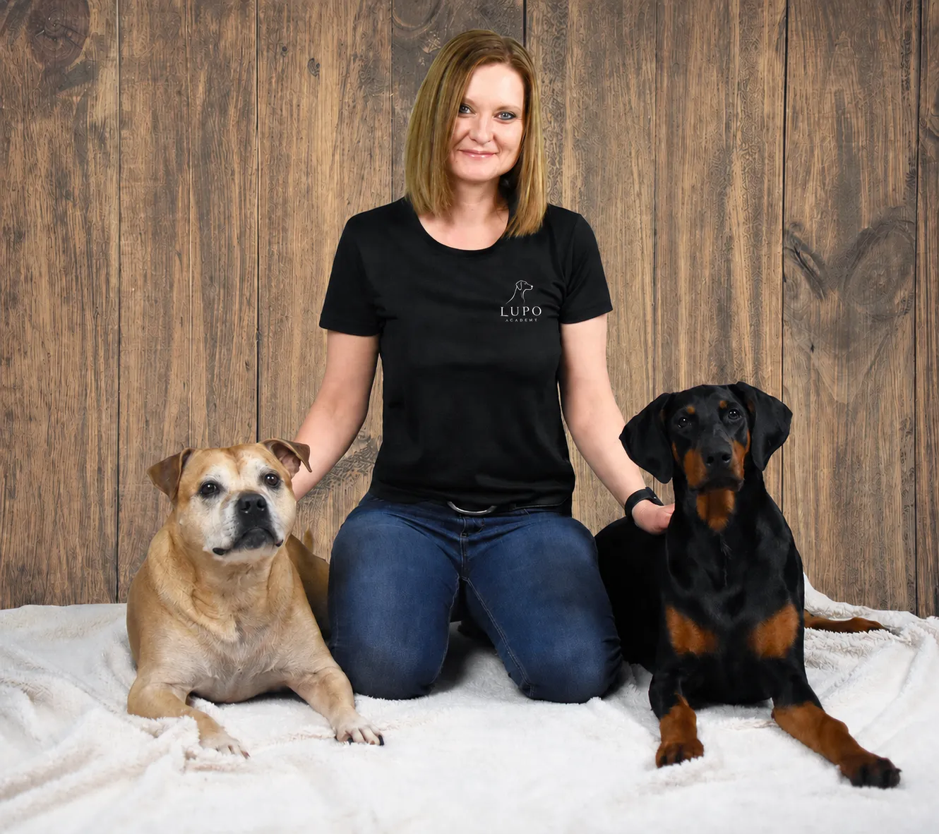 Dog trainer Tracey with two dogs at Lupo Academy